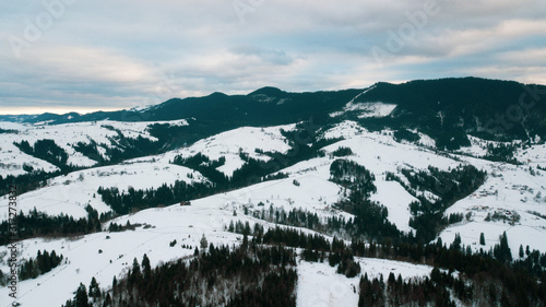Beautiful landscape with mountain peaks covered with snow and clouds