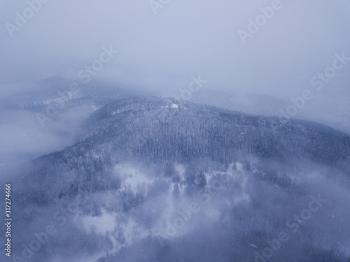 Beautiful landscape with mountain peaks covered with snow and clouds