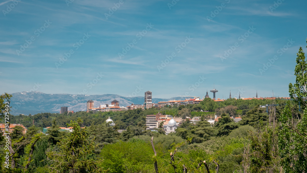 Panoramic view of the downtown Madrid with Moncloa tower from the famous park Las Vistillas in Spain on a sunny day during the traditional festival in May called San Isidro in the capital of Spain