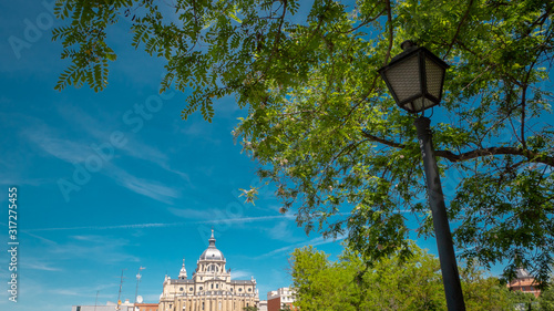 Panoramic view of Almudena cathedral from the famous park Las Vistillas in the downtown Madrid, Spain on a sunny day during the traditional festival in May called San Isidro in the capital of Spain photo