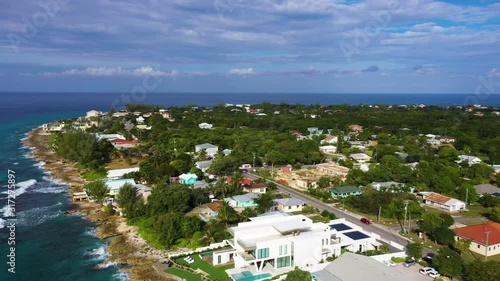 aerial drone footage of seven mile beach, west bay and george town on the island of grand cayman in the cayman islands in the clear blue and green tropical waters of the caribbean sea