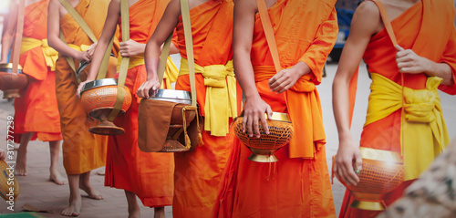 Photos Buddhist monks carrying their alms bowls.
