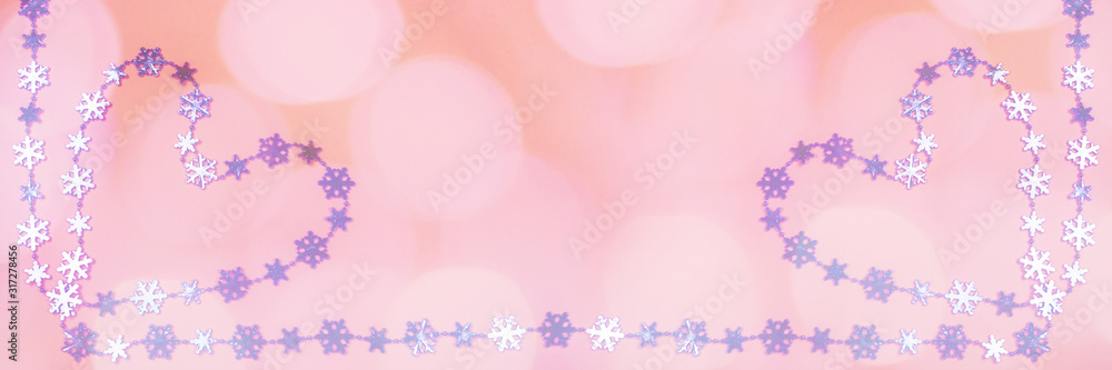 Creative wide Valentine's day banner with two heart of shiny lilac metallic snowflakes on pink background with bokeh. 