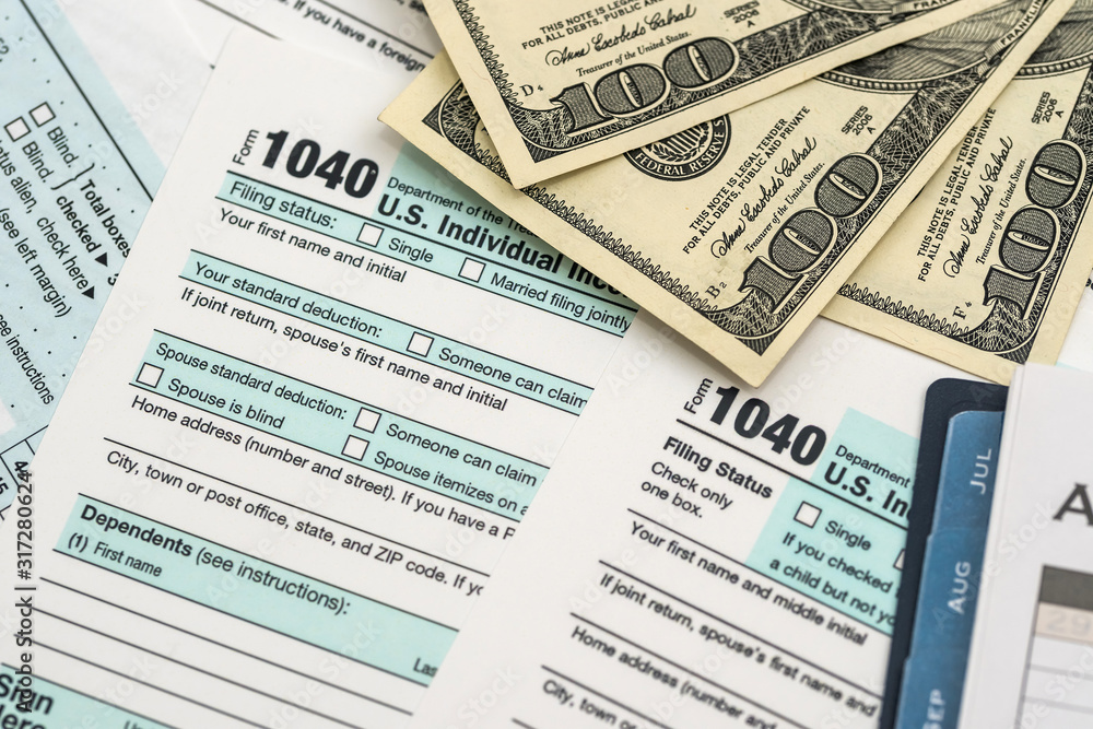 Tax form with dollar, calculator and pen Tax form with dollar, calculator and pen
