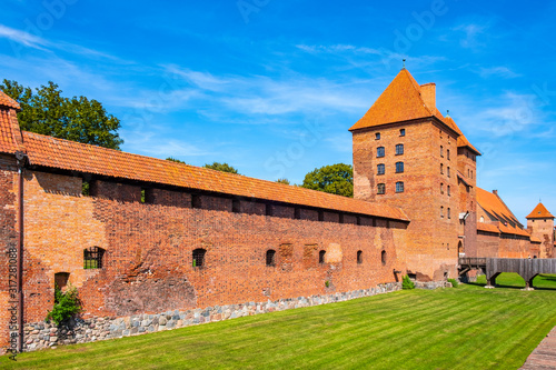 Panoramic view of the medieval Teutonic Order Castle in Malbork, Poland - external defense walls, towers moat and keeps