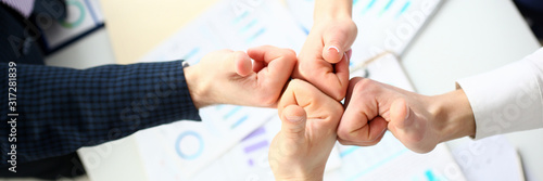 Photos Close-up of friendly business collective performing cooperation gesture to greet presumptive boss or colleagues and show increased level of cohesion and solidarity