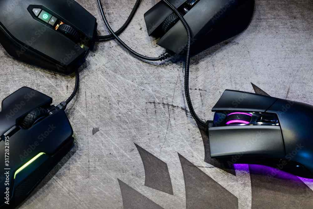 Close-up group of modern gaming mouse on black color with LED RGB light  show status on working mode placing on gaming mouse pad on top-view,  e-sport concept Stock Photo | Adobe Stock