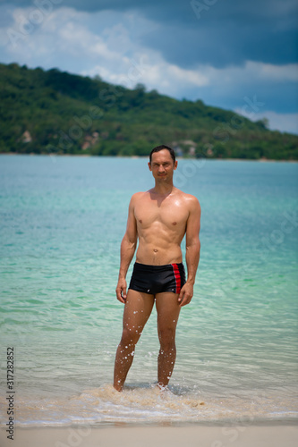Portrait of a handsome happy man at tropical resort with smile