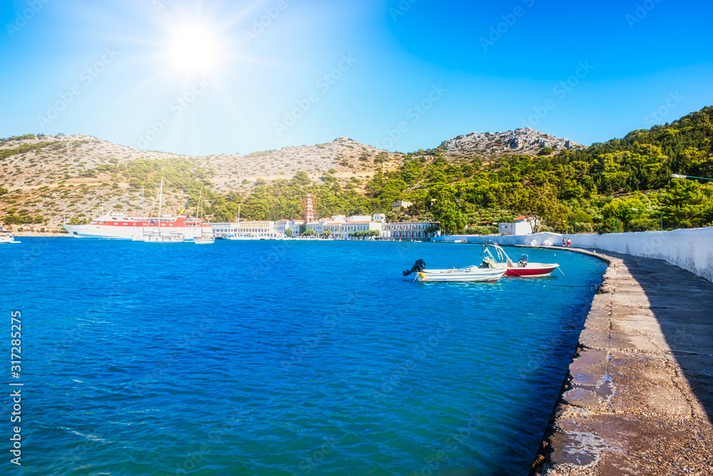 View of bay with boats and Monastery of Taxiarchis Mihail Panormitis on Island of Symi  (Rhodes, Greece)