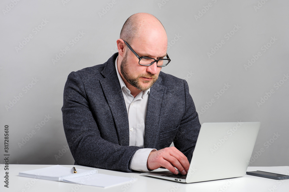 A man works with a laptop. Manager is sitting at the table. A man works with a laptop. Manager is sitting at the table.