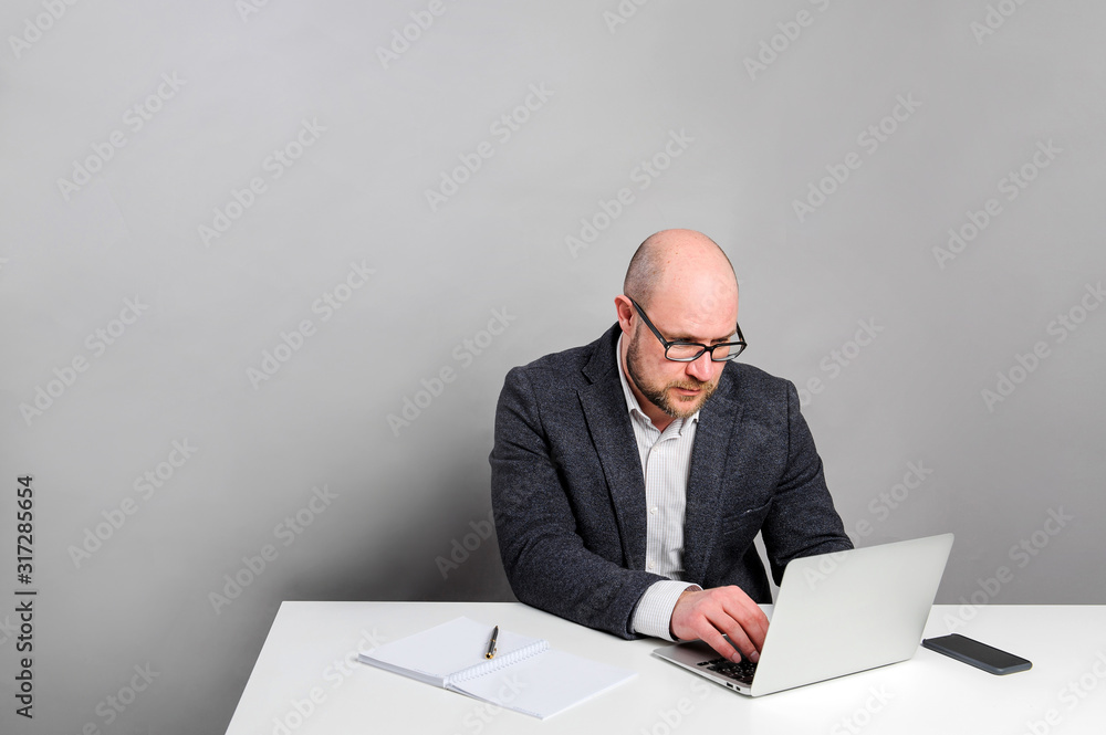 A man works with a laptop. Manager is sitting at the table. A man works with a laptop. Manager is sitting at the table.