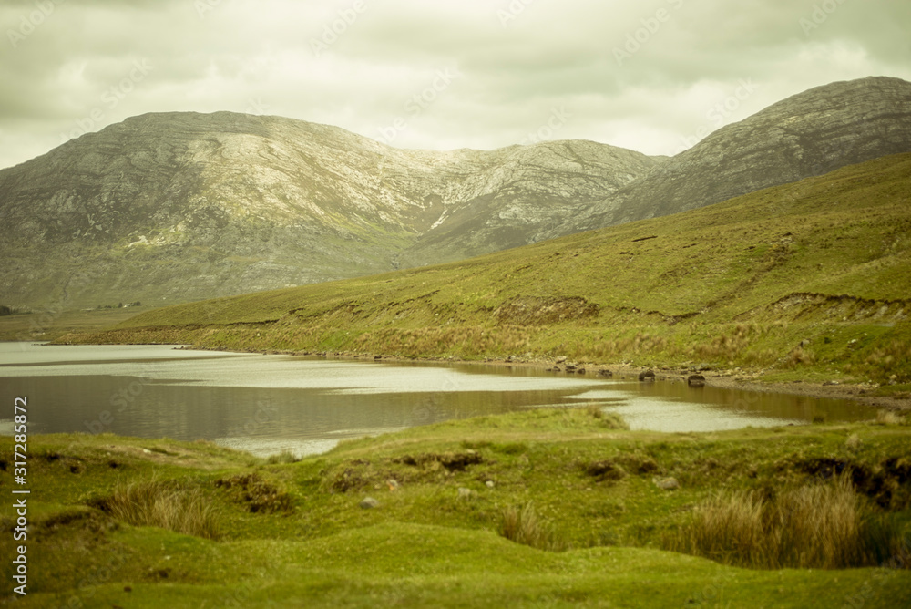 Beautiful lake called Lough Inagh in County Galway, Ireland. Landscape with mountains in the background.