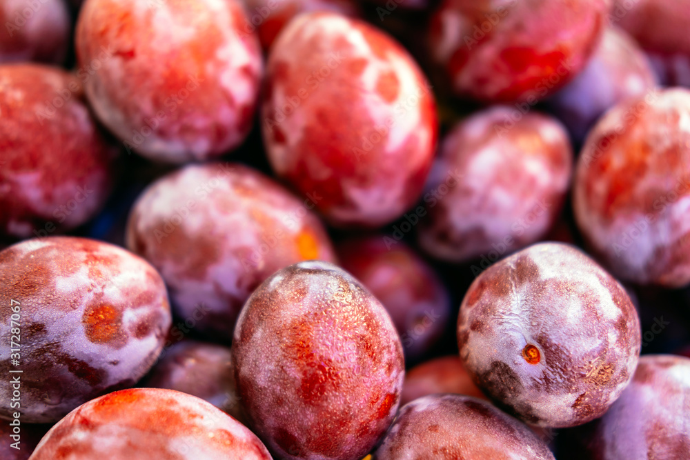 Obraz premium Banner of exotic summer diet. Tropical organic fruit. Plum delivery. Autumn harvest. Stock photo.