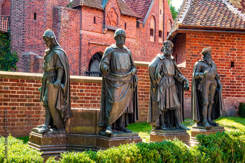Statues of the major Teutonic Order great masters at the Middle Castle fortress inner courtyard of the Medieval Teutonic Castle in Malbork, Poland photo