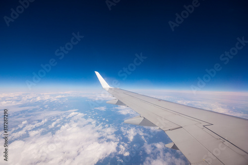Aeroplane wing in blue sky