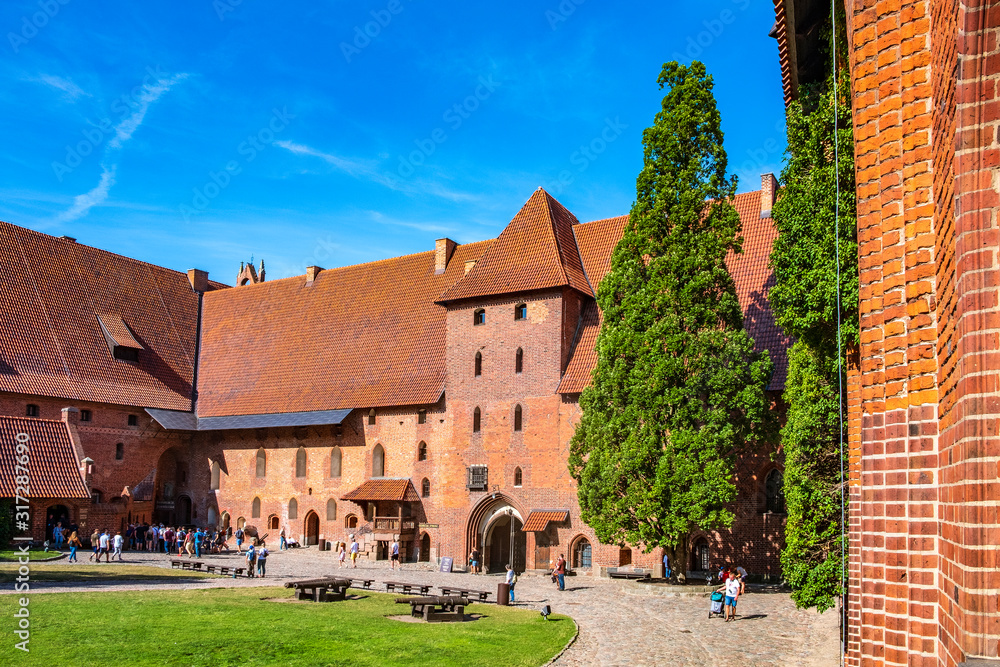 Middle Castle fortress inner courtyard with the gate tower of the Medieval Teutonic Order Castle in Malbork, Poland Middle Castle fortress inner courtyard with the gate tower of the Medieval Teutonic Order Castle in Malbork, Poland