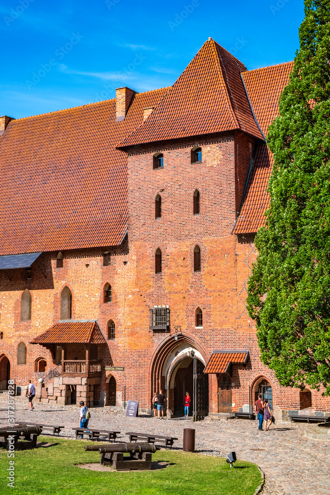 Middle Castle fortress inner courtyard with the gate tower of the Medieval Teutonic Order Castle in Malbork, Poland