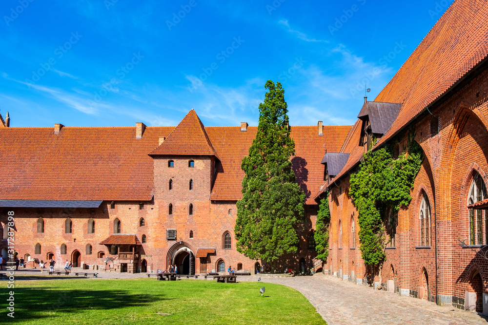 Middle Castle fortress inner courtyard with the gate tower of the Medieval Teutonic Order Castle in Malbork, Poland
