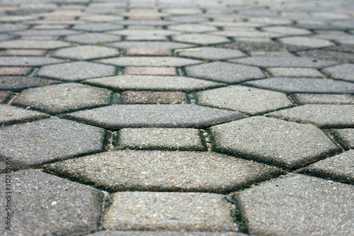 Brick path with blurred background, side walk, abstract pattern.