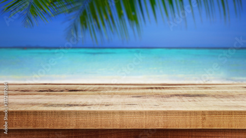 Blurred nature summer tropical beach and palm leaves background, Empty wooden. 