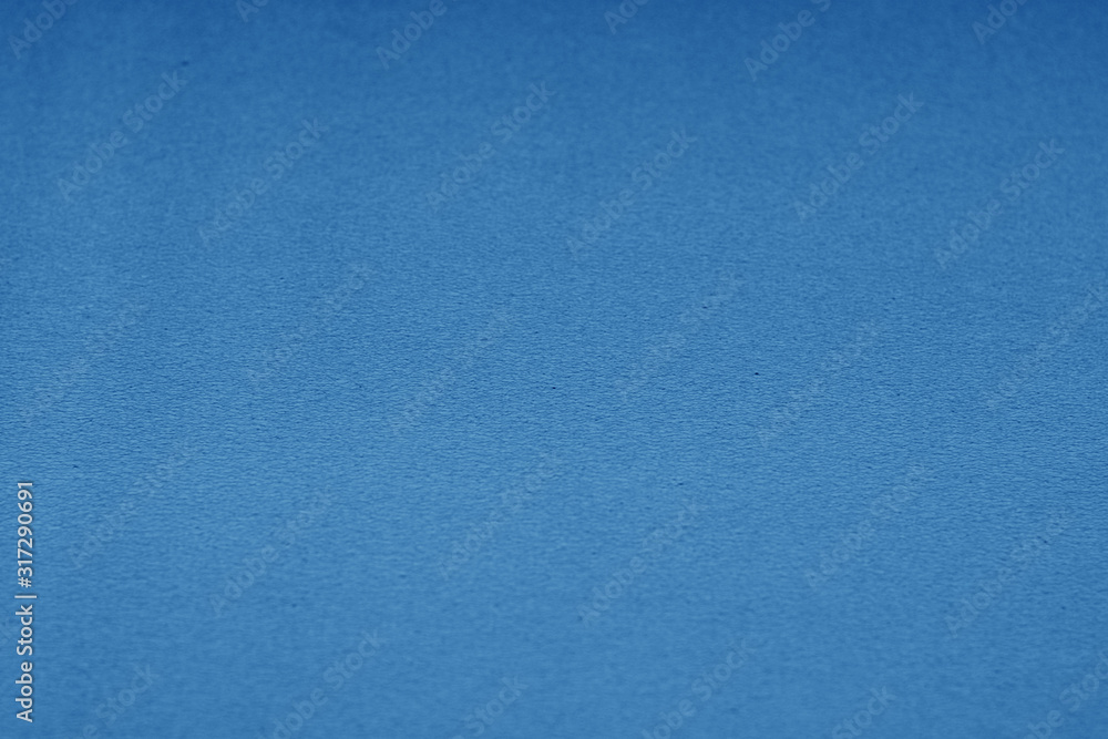 Plastic glittering texture with blur effect in navy blue tone.