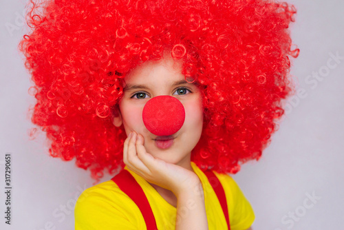 Let's celebrate! Funny kid clown playing at home. 1 April Fool's day concept.