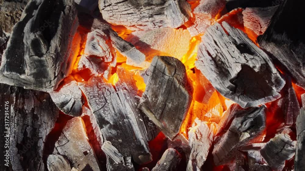 Close up of charcoal is starting to burn in the kitchen grill. Hot charcoal and flame with smoke. Close up of charcoal is starting to burn in the kitchen grill. Hot charcoal and flame with smoke.