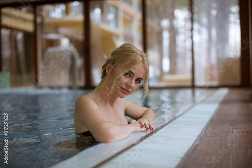 Young woman relaxing in spa swimming pool