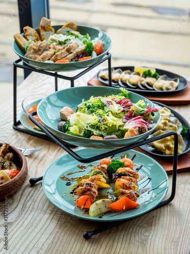 Different dishes on the table in a cafe, restaurant interior