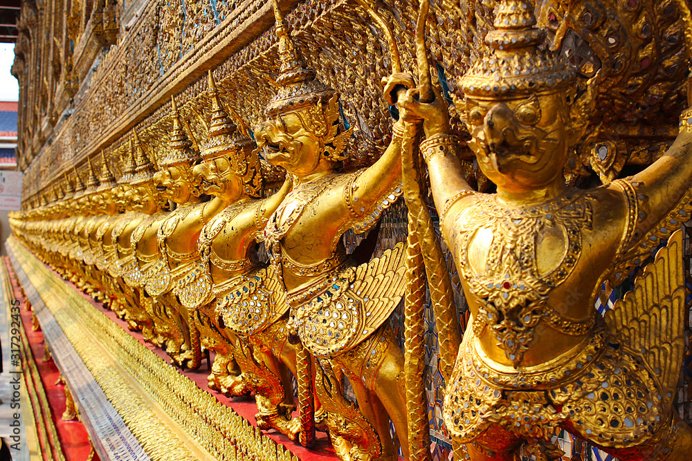 Golden Garuda statues lined up in order at the Thai temple
