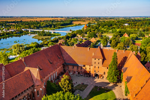 Aerial panoramic view of the inner courtyard with the gate tower in the Middle Castle part of the medieval Teutonic Order Castle by the Nogat river in Malbork, Poland photo