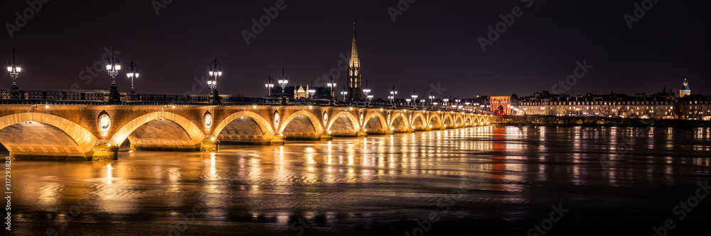 Bordeaux skyline at night with the Pont de Pierre bridge and the Garonne river