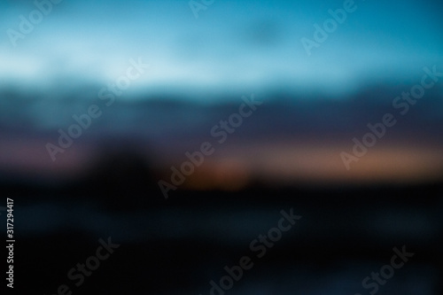 blurred blue sky at twilight with toptrees