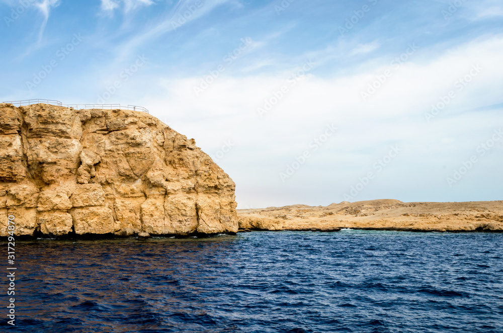 rocky coast of the Red Sea and.blue sky with clouds