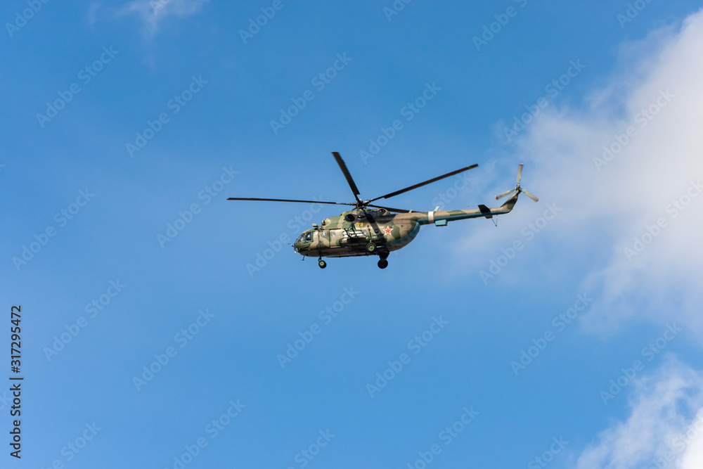 The military helicopter against the blue sky. The military helicopter against the blue sky.