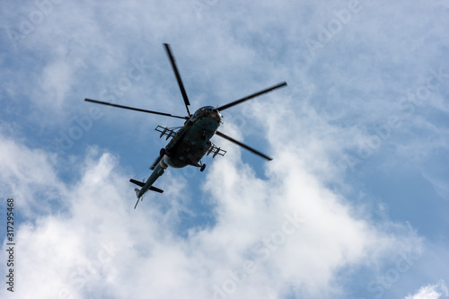 Military helicopter flies in the sky