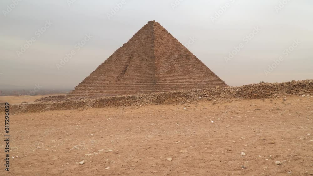 Pyramid of Menkaure in Giza against the backdrop of an overcast sky. Egypt Pyramid of Menkaure in Giza against the backdrop of an overcast sky. Egypt
