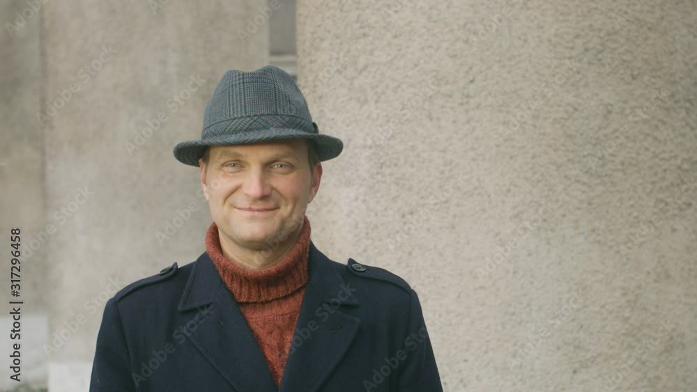 Portrait of a confident young man smiling at the camera. handsome man in a hat. Lifestyle concept Portrait of a confident young man smiling at the camera. handsome man in a hat. Lifestyle concept