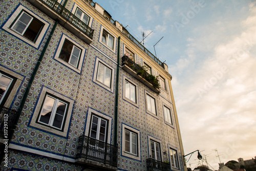Blue and white facade building with typical portuguese tiles on the wall, Portugal, Lisbon. Sunbath photography