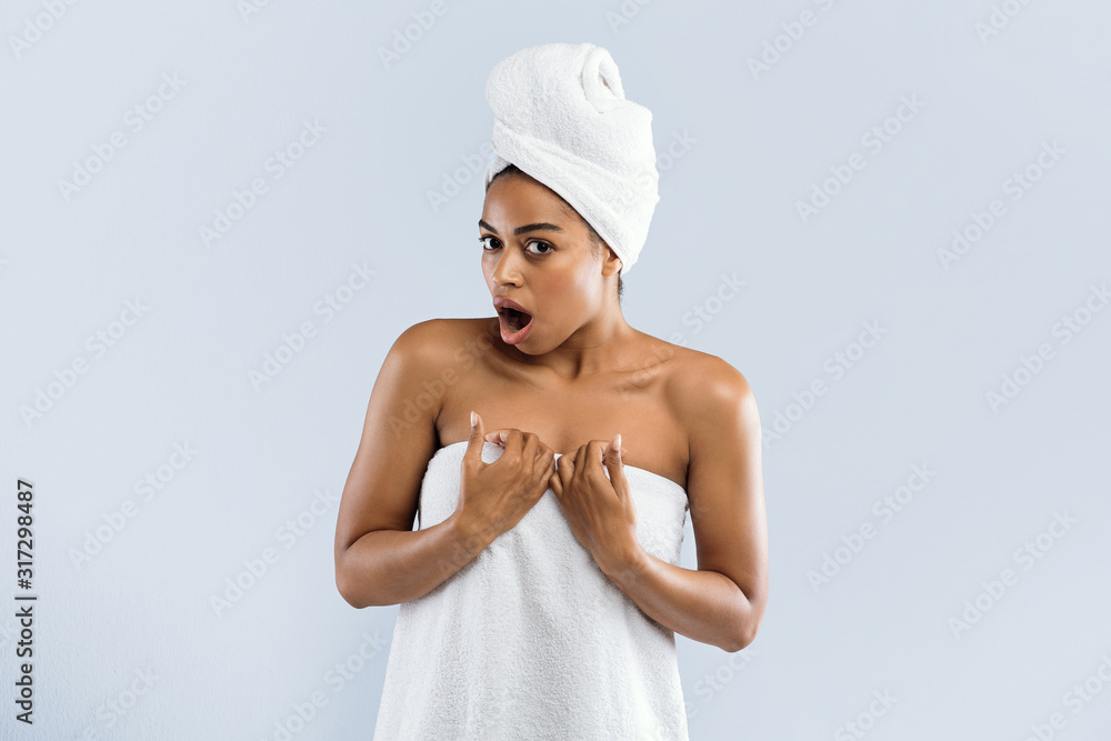 Black woman in towels expressing shocking emotions Black woman in towels expressing shocking emotions