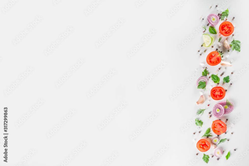 Fresh cherry tomatoes with basil, herbs and spices on white background, copy space for text top view. Ripe raw vegetables flatlay. Cooking food background, simple pattern