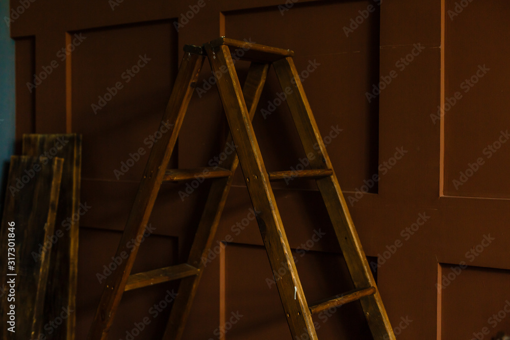 Old stepladder in an abandoned house. Repairs. Old stepladder in an abandoned house. Repairs.