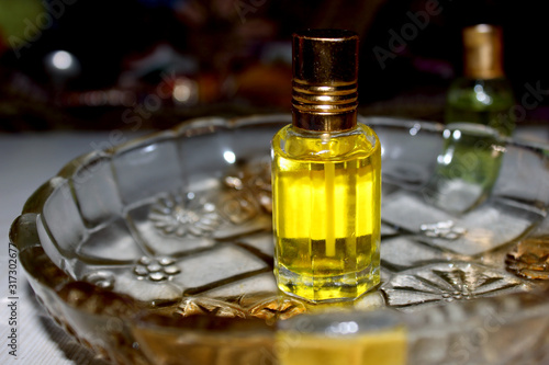 Beautiful composition with bottle of perfume, aromatic oil in glass bowl