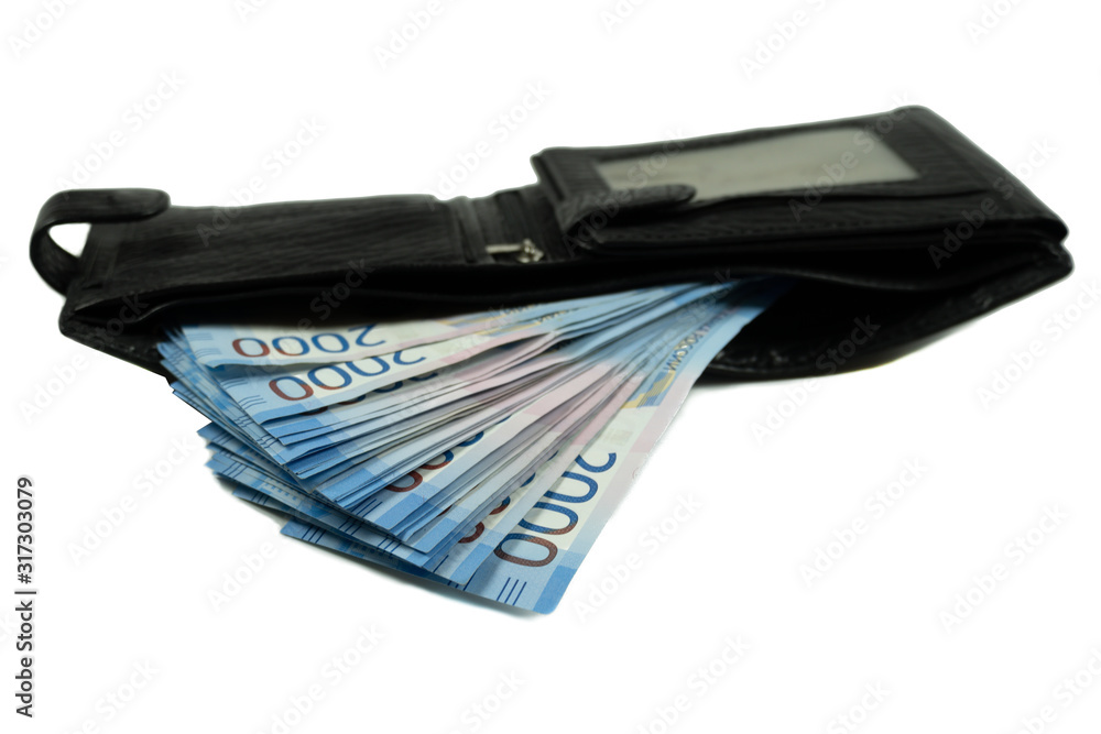A bundle of Russian money is in the wallet. Isolated money on a white background. A hand holds a salary of Russian rubles for 2000 two thousand. A bundle of Russian money is in the wallet. Isolated money on a white background. A hand holds a salary of Russian rubles for 2000 two thousand.