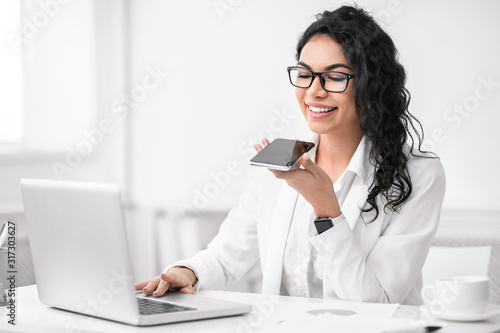 Latin woman using mobile voice recognition function