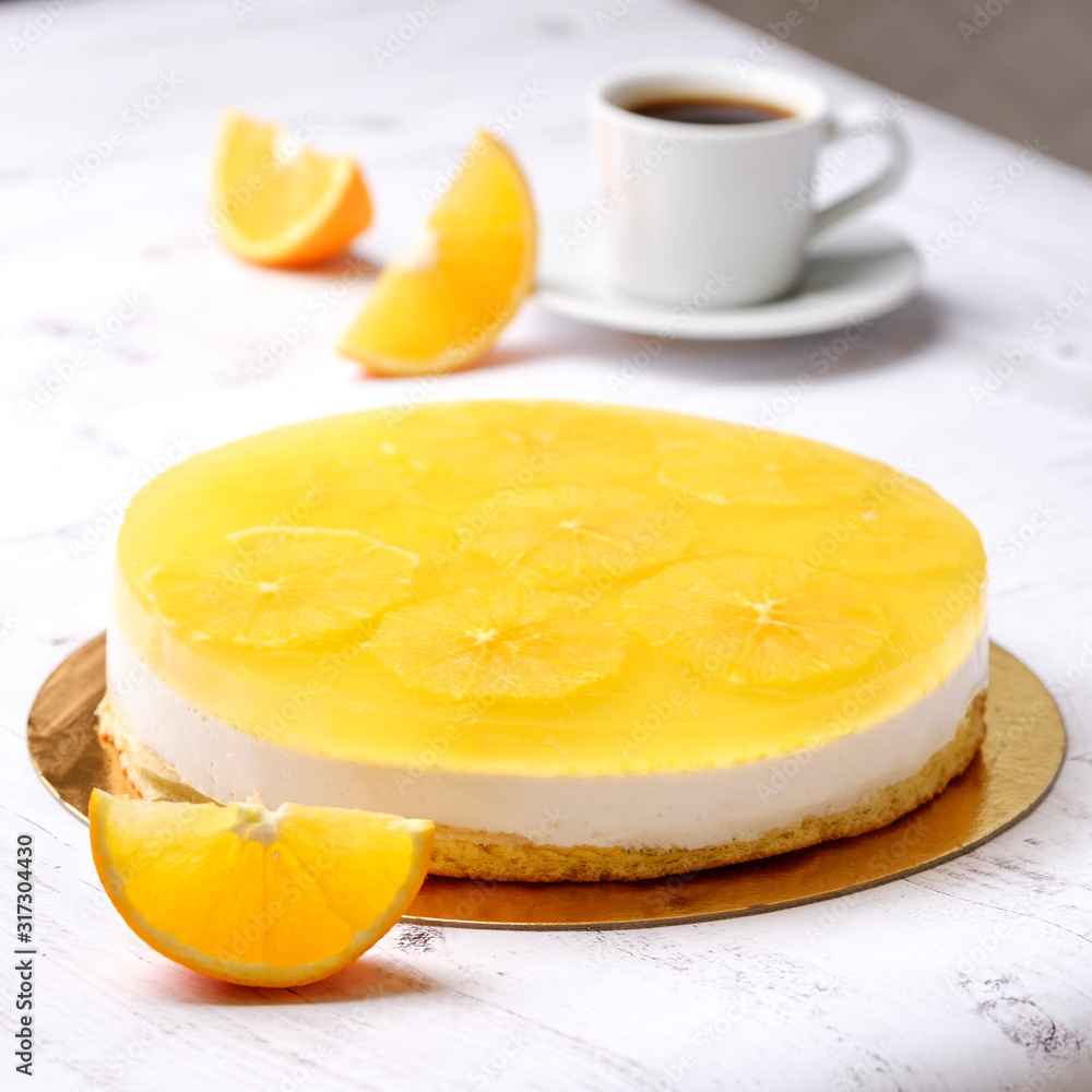 Homemade delicious sweet passion fruit orange cake, mousse dessert on cup of coffee americano, white background. Organic dessert sugarless. Healthy eating. Homemade delicious sweet passion fruit orange cake, mousse dessert on cup of coffee americano, white background. Organic dessert sugarless. Healthy eating.