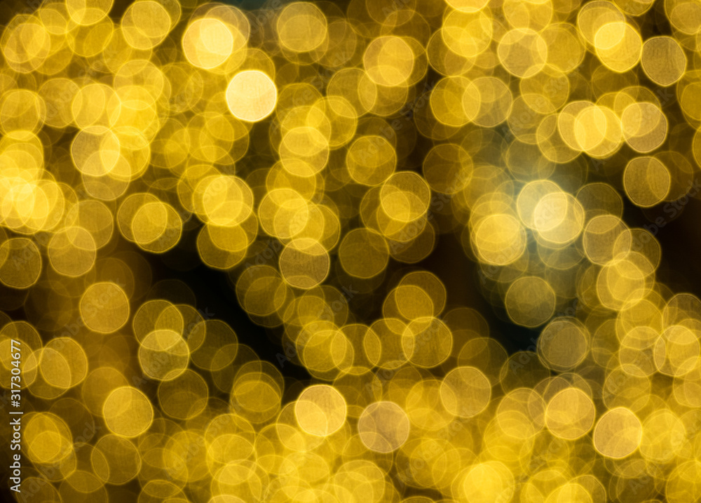 Glittering golden light spots on black background. Blurry festive pattern Glittering golden light spots on black background. Blurry festive pattern