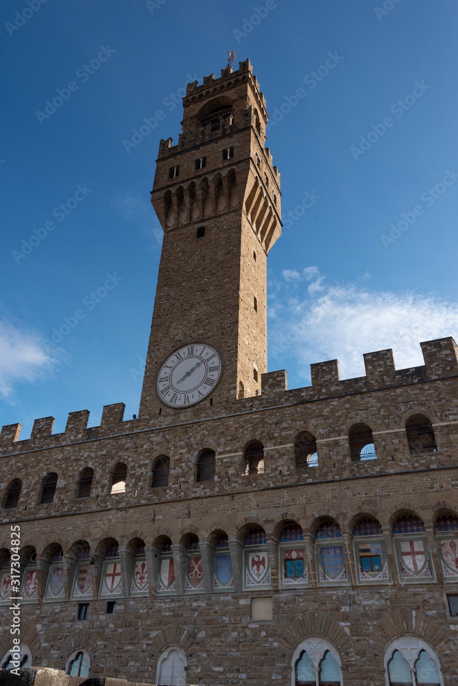 view of the old building facade with bell tower in Florence Tuscany