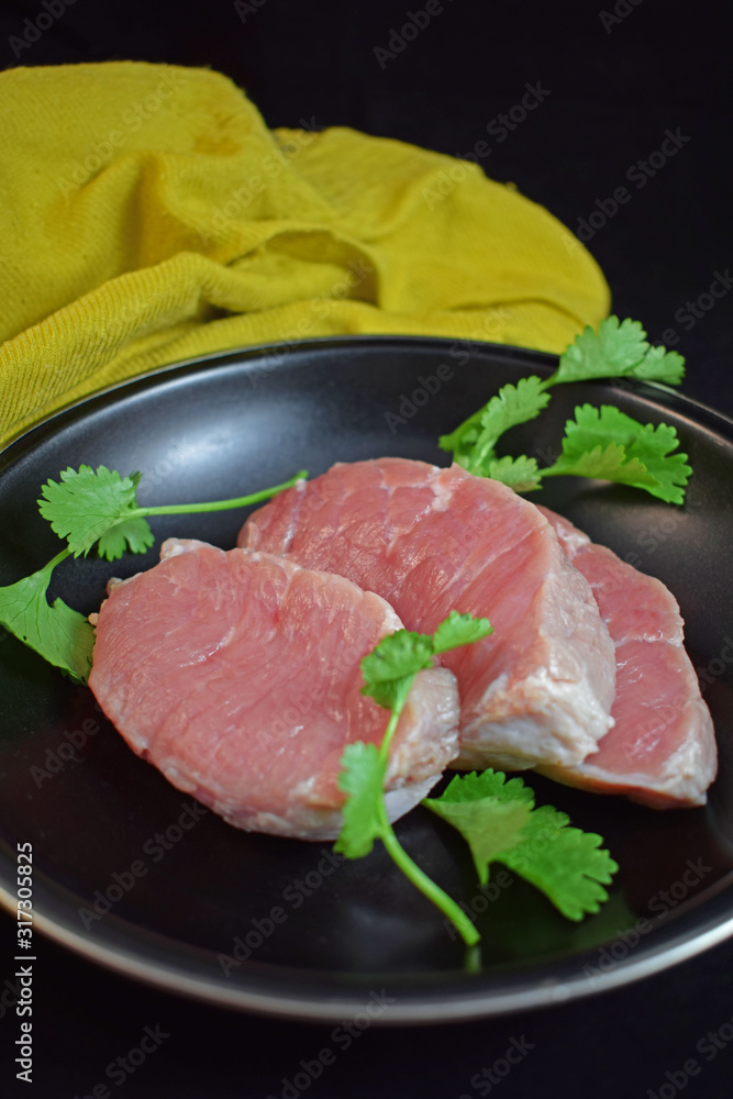 Raw meat in a pan with herbs.Steak. Raw meat in a pan with herbs.Steak.