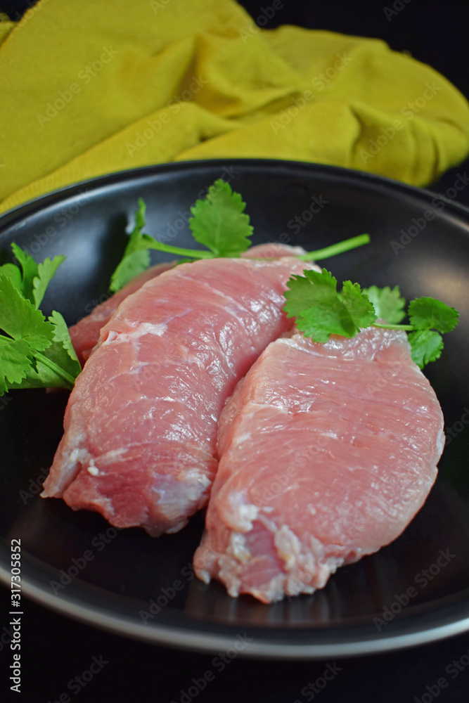 Raw meat in a pan with herbs.Steak.